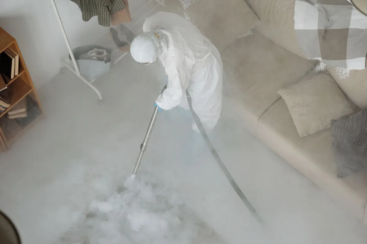Biohazard cleanup technician in protective equipment, Fulton, MS